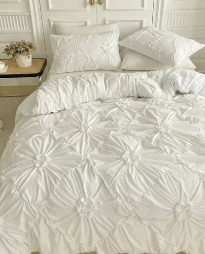 White ruched duvet cover set styled in bright modern bedroom with soft textured bedding