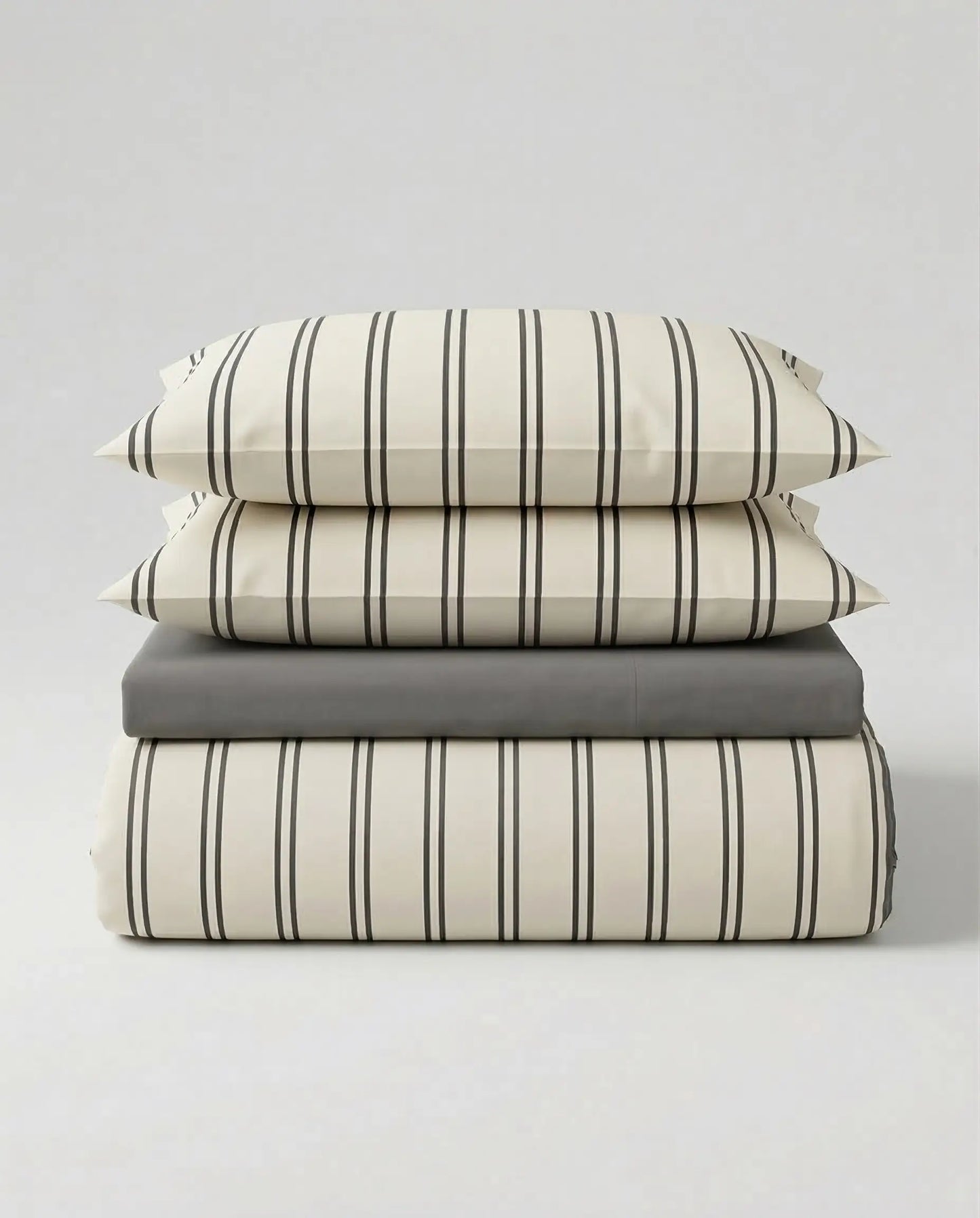 Stacked view of the DORMÉ Studio Urban Stripe Duvet Cover Set featuring soft ivory cotton bedding with thin charcoal pinstripes and matching pillow shams. This modern striped duvet cover set offers a clean, minimalist aesthetic and timeless neutral design that elevates any bedroom with hotel-inspired comfort and refined style.